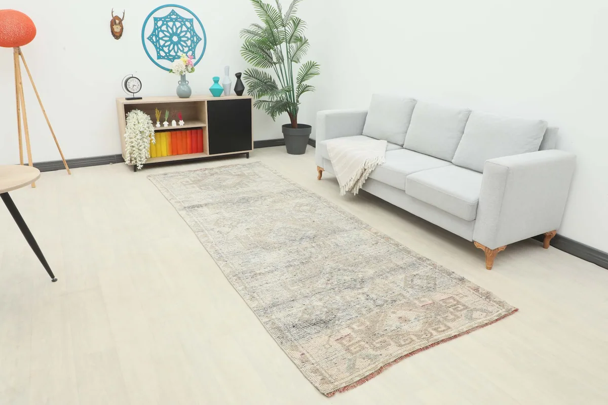 Long view of the gray and beige runner in a living space with a sofa, highlighting its fit