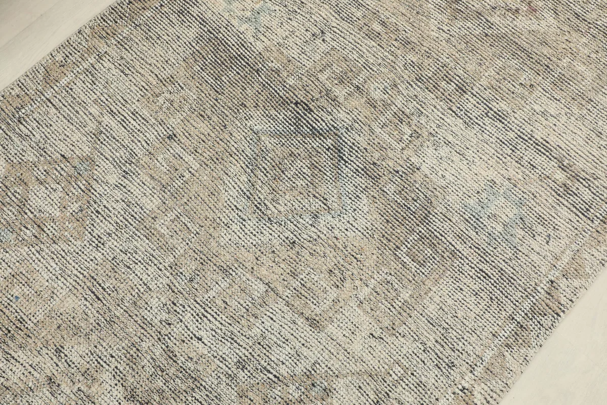 Detailed view of the low pile, showing variations in gray, beige, and traces of blue