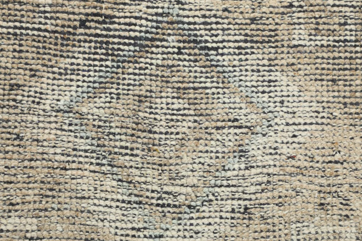 Close-up of the hand-knotted cotton foundation visible from the back of the rug