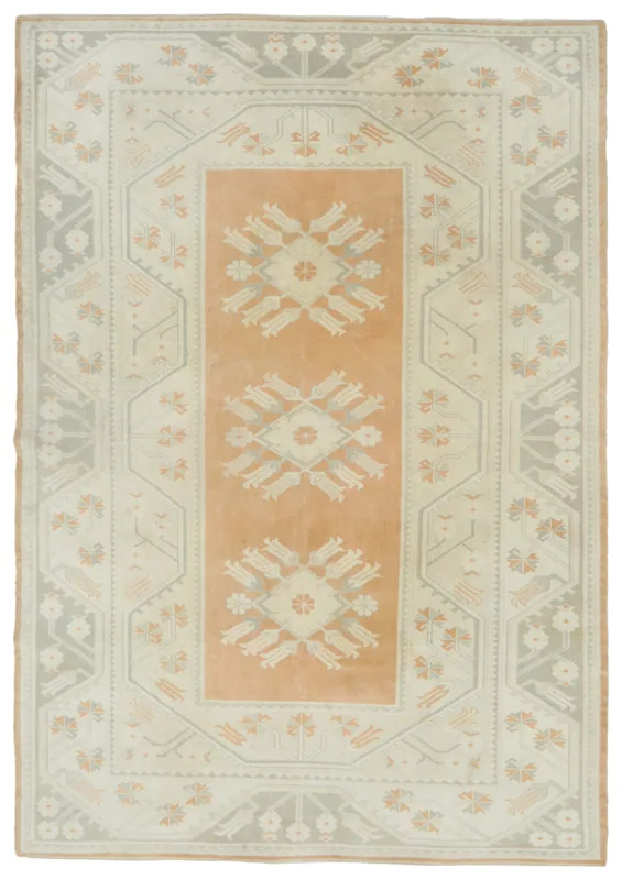 Full top view of the orange and ivory vintage Anatolian area rug with geometric floral motifs.