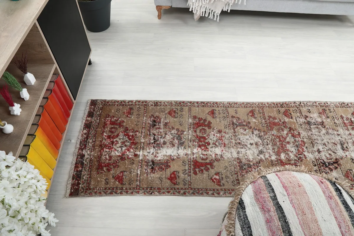 Side view of the runner rug in a room, emphasizing its long, narrow shape.