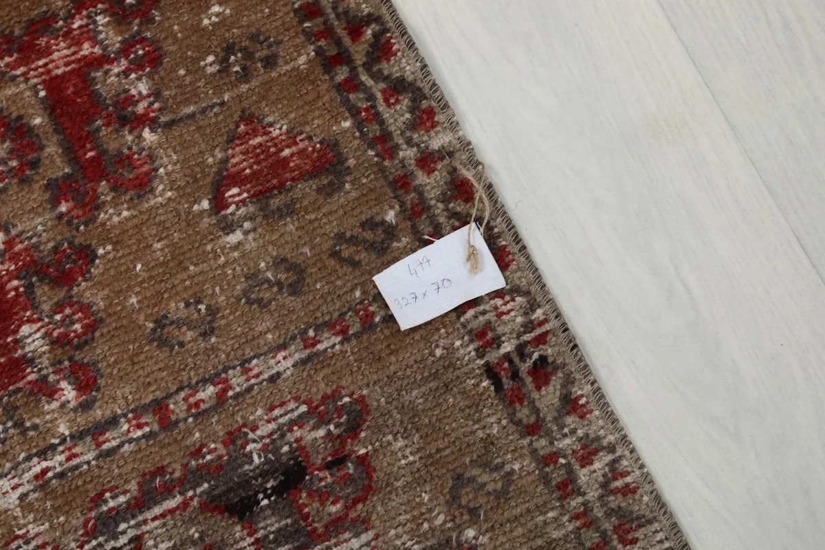 Close-up of the rug's surface with a product tag, detailing the texture and colors.