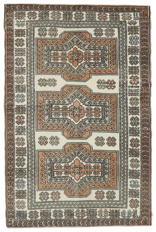 Full top view of the 4'1" x 6'2" vintage Anatolian rug with ivory, rust, and gray geometric patterns