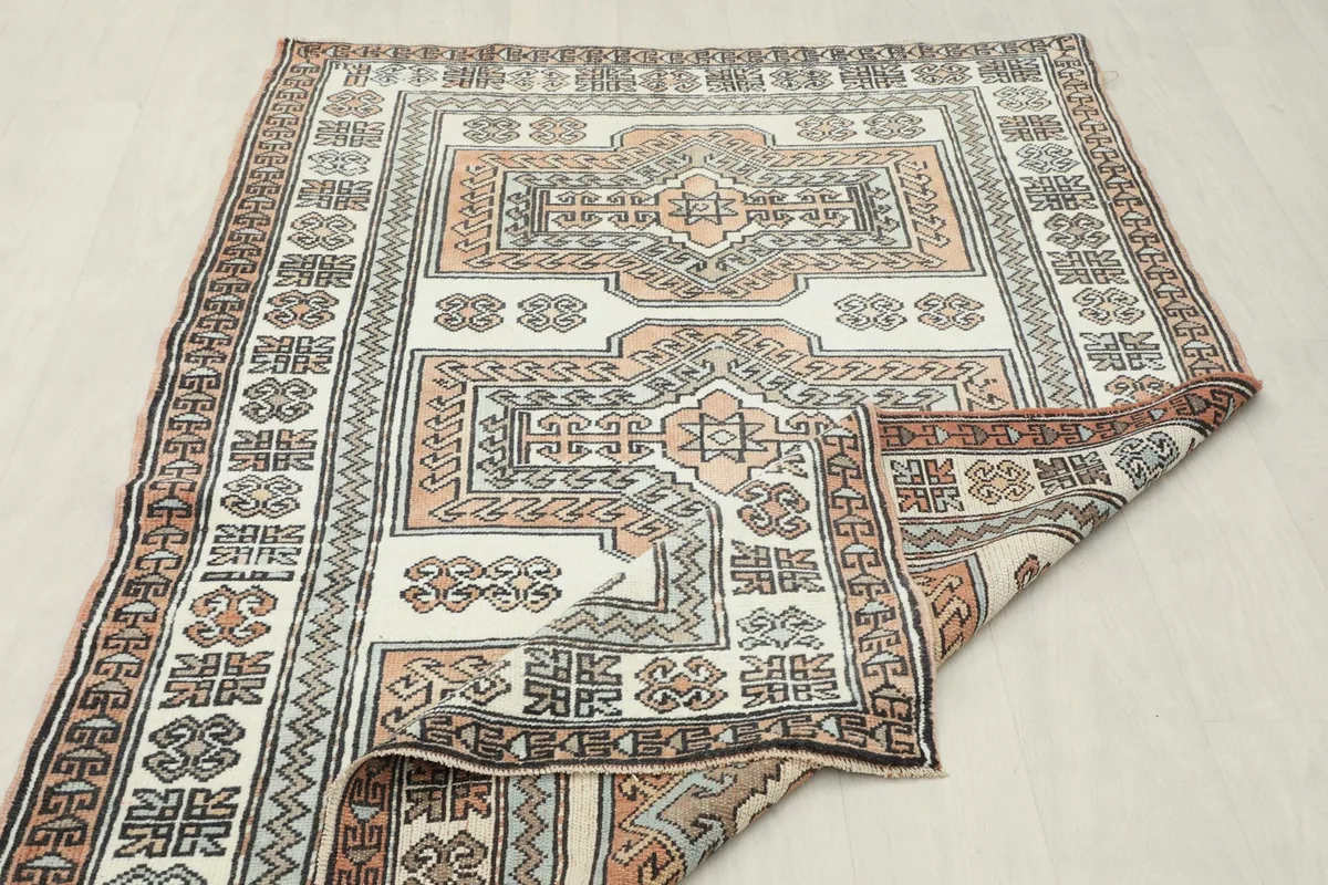Rug partially folded, displaying the overall pattern and texture