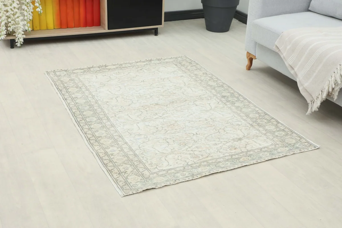 Angle view of the ivory and rose floral rug placed in a contemporary room interior