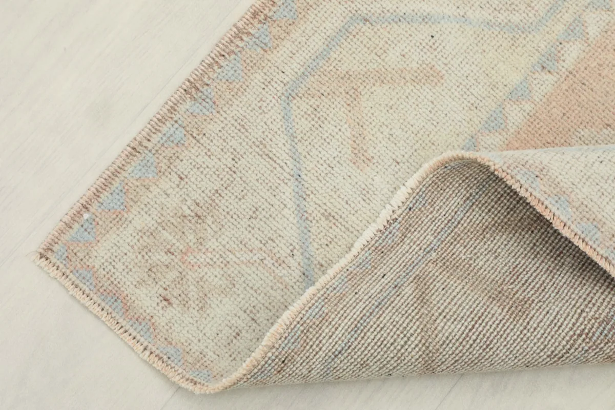 Corner view showing the cotton foundation and reverse side of the hand-knotted vintage rug