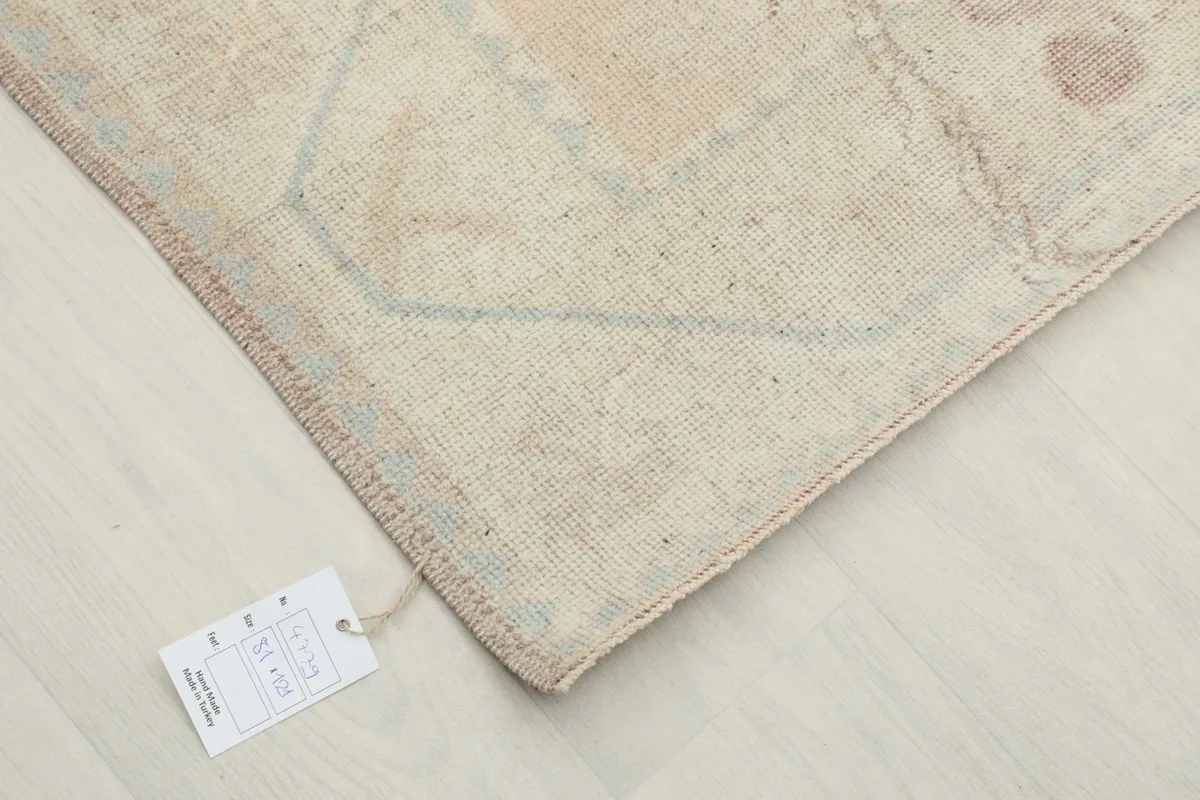 Corner of the rug with a product tag, indicating its origin and materials