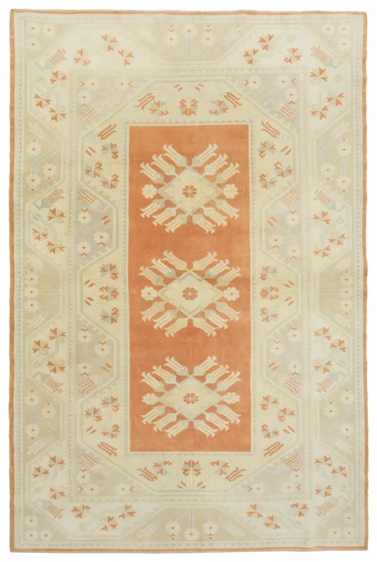 Full top view of the 6'5" x 9'8" vintage Anatolian rug with rust field and cream border.