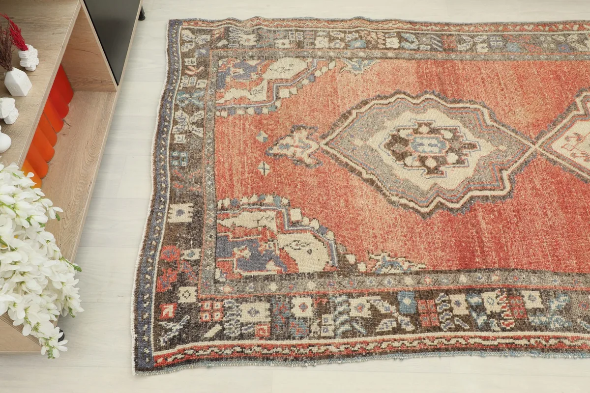 Overhead angled shot of the runner rug showing the color variations and texture of the wool pile.
