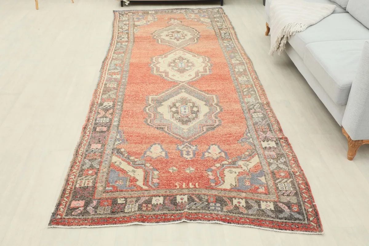 Full view of the rust runner rug laid out in a room setting, emphasizing its overall appearance.