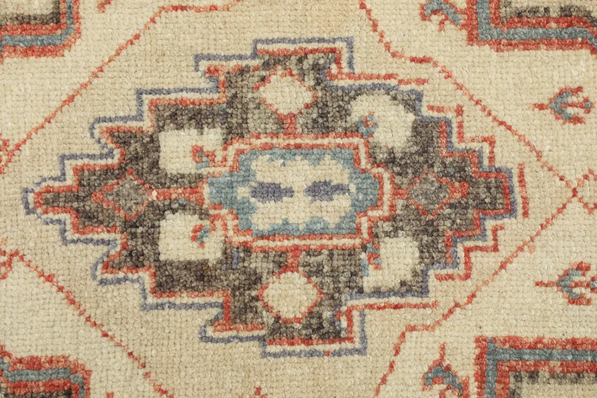Extreme close-up of the intricate weaving and color details within a medallion motif.