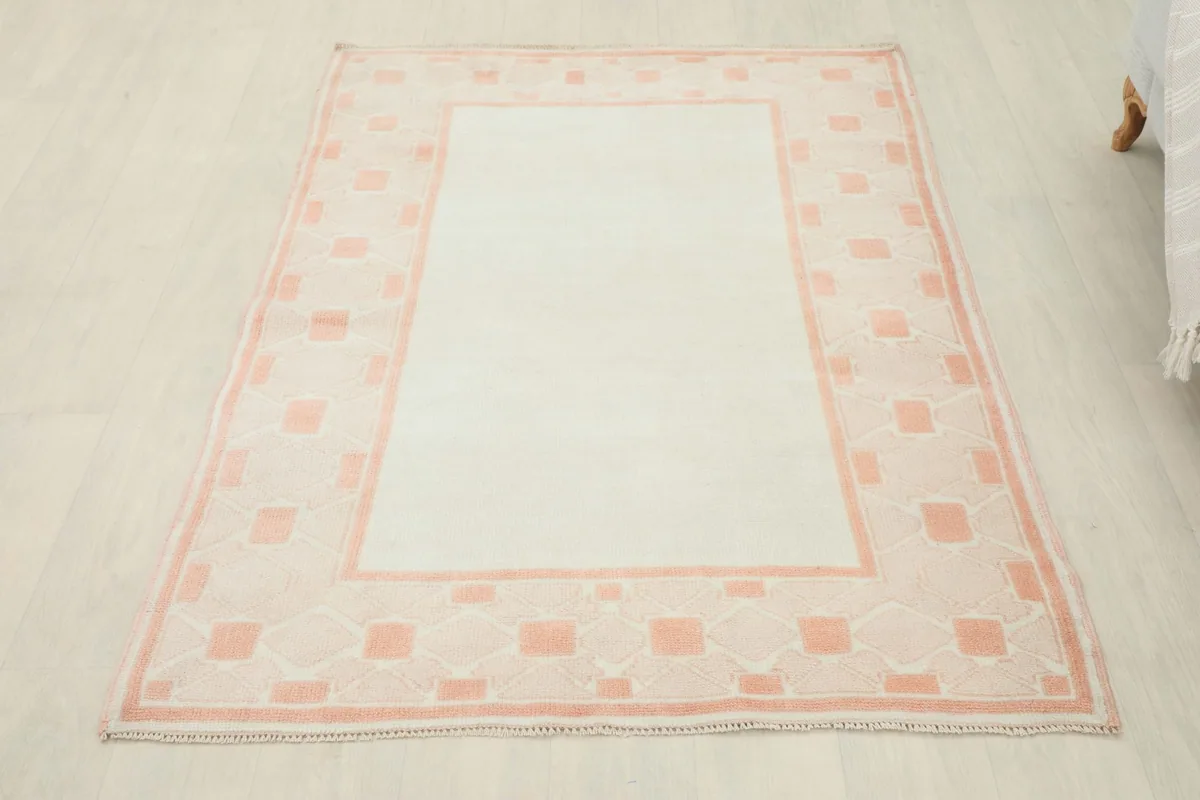 Full overhead view of the ivory and rose vintage Anatolian area rug