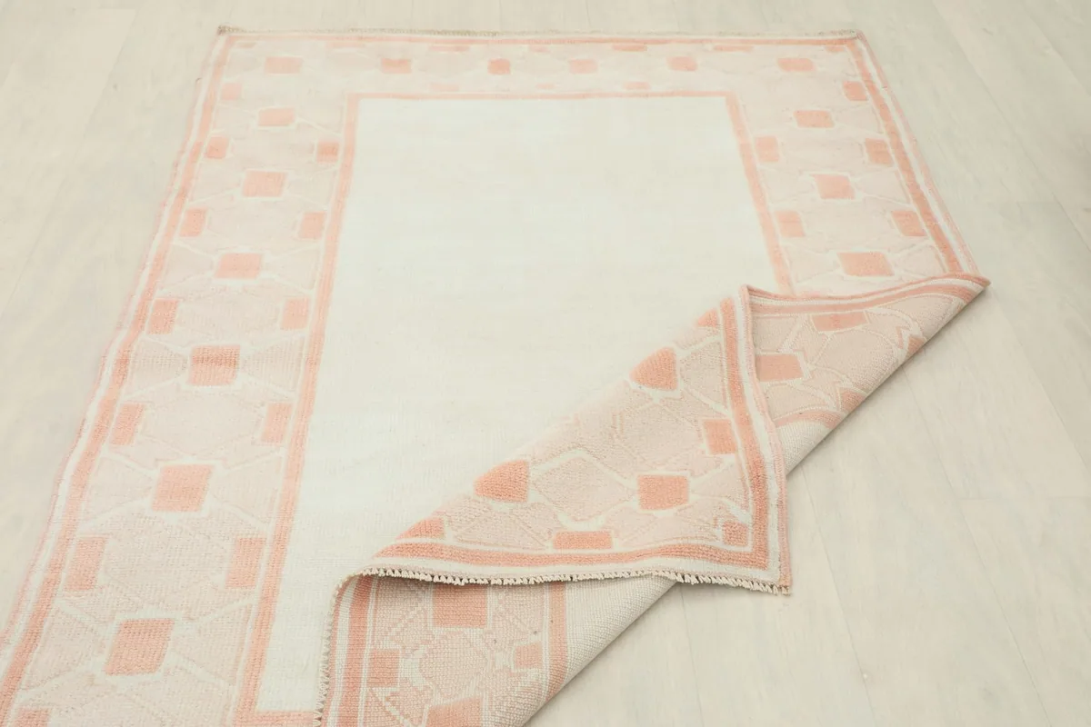 Underside view of the rug showing the cotton foundation and hand-knotted construction