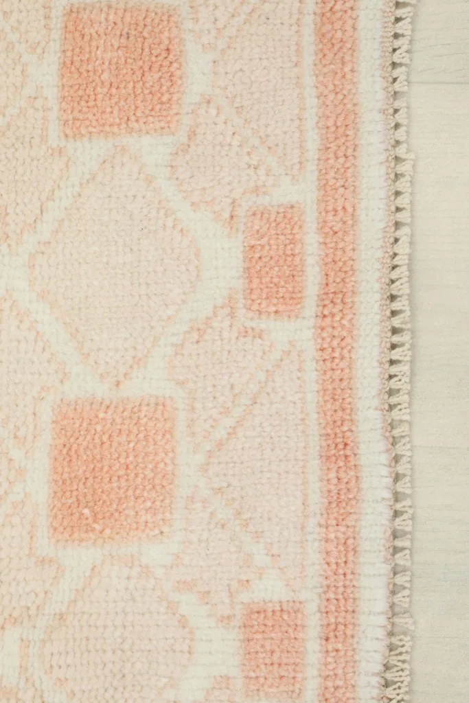 Edge detail showing the hand-knotted construction and short, natural fringe