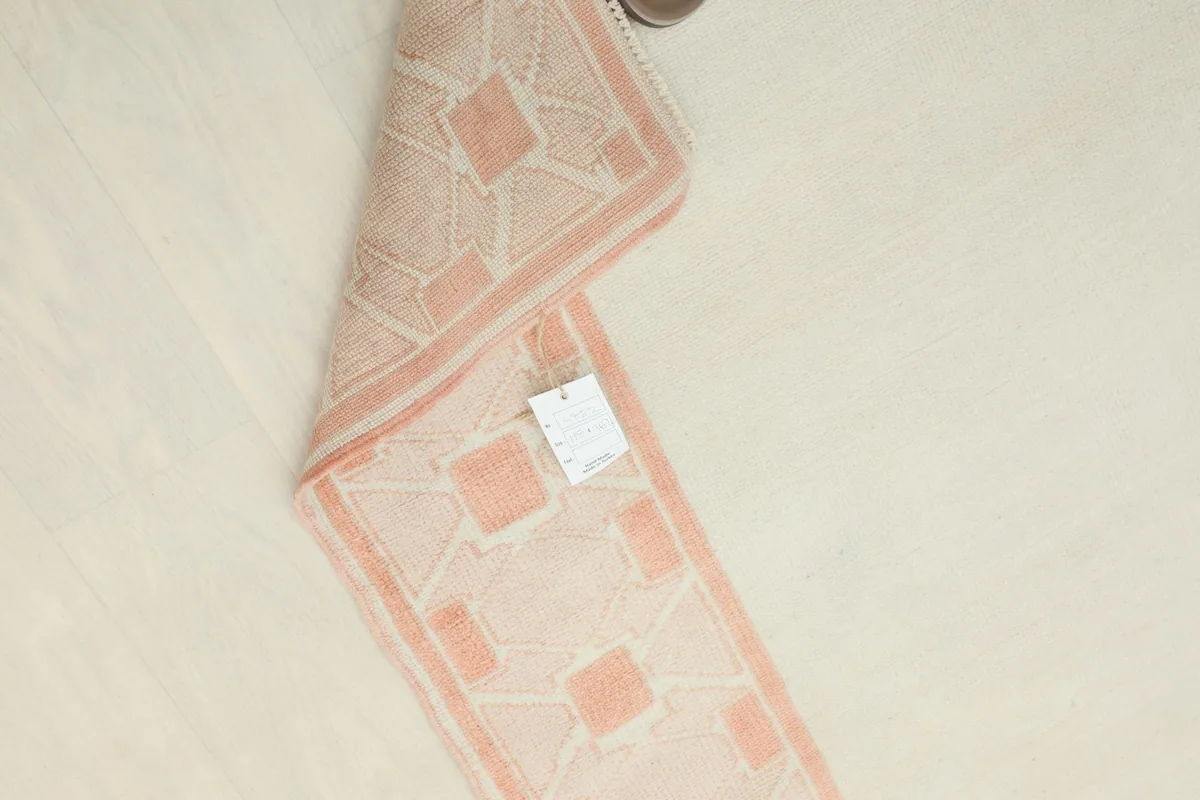 Rug folded with a product tag visible, highlighting its authenticity