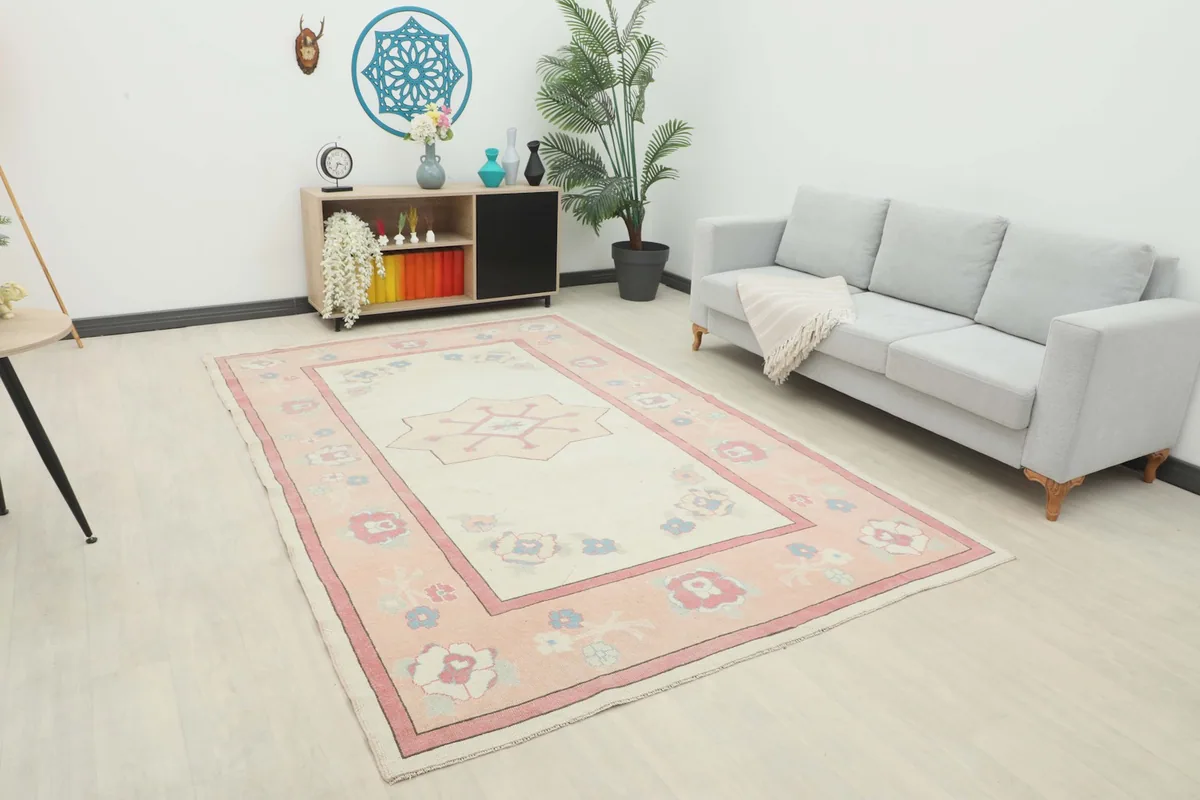 Vintage Anatolian rug displayed in a bright living room setting with a light gray sofa