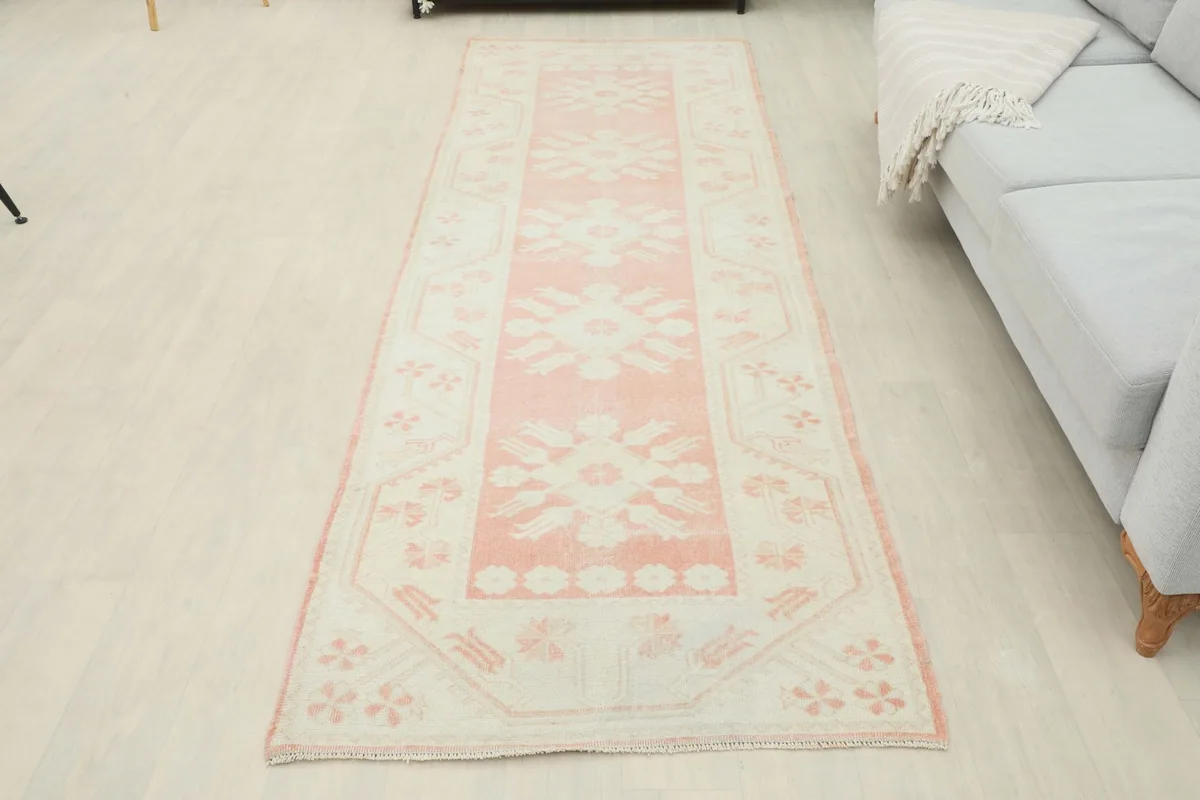 Full view of the rose and ivory runner in a room, showcasing its length and placement