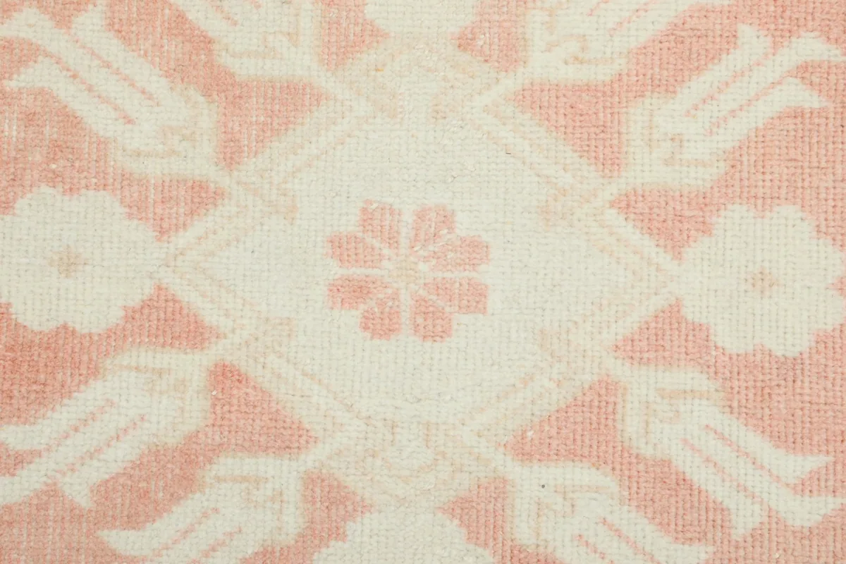Tight detail shot of a central geometric medallion and surrounding tulip-like motifs