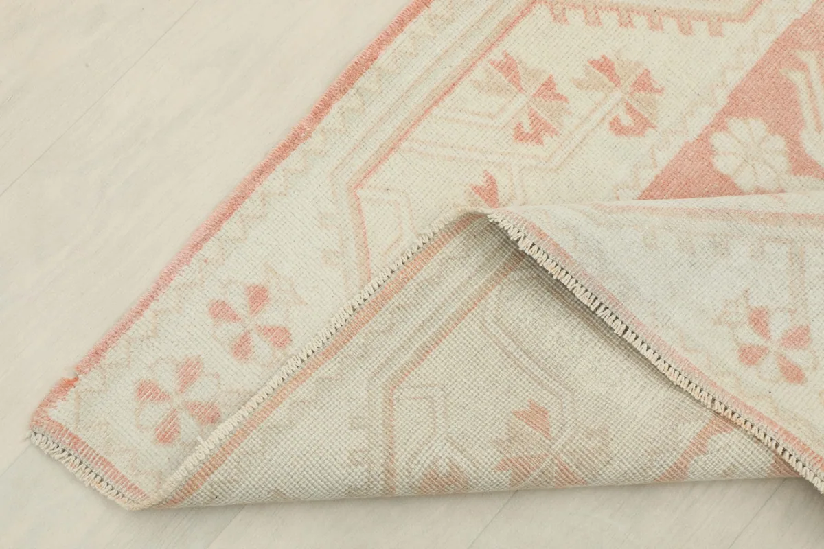 Detail of the back of the runner, showing the hand-knotted construction and cotton foundation
