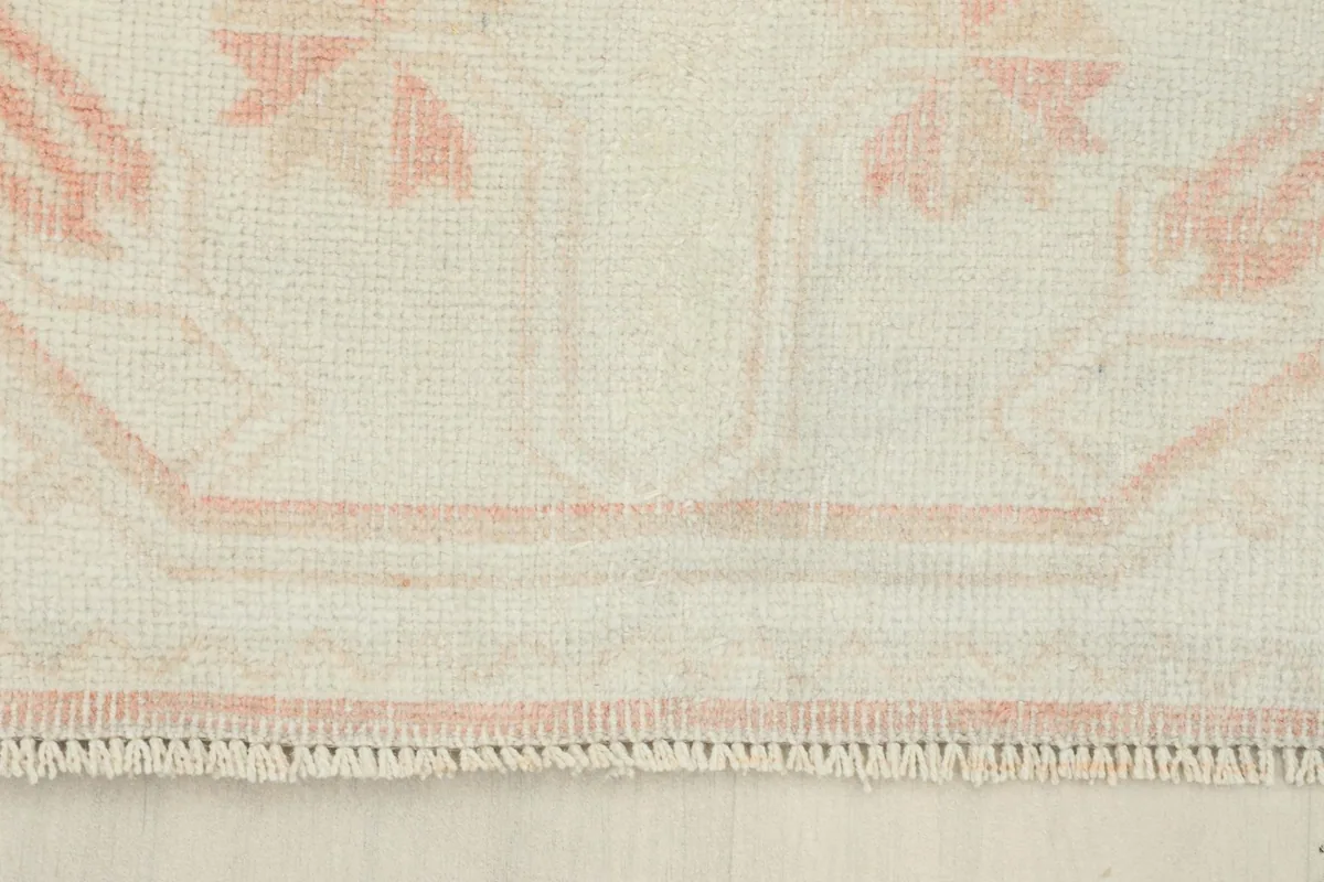 Close-up of the short fringe and the finished edge of the hand-knotted vintage runner