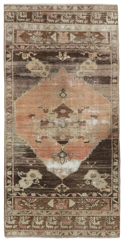 Overhead view of a 3'1" x 6'4" rust and brown vintage Anatolian rug with a central medallion