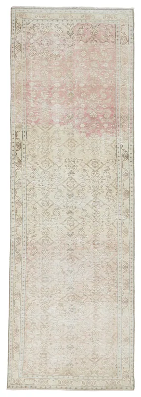 Full overhead view of the vintage Anatolian runner rug with rose and beige tones on a white background.