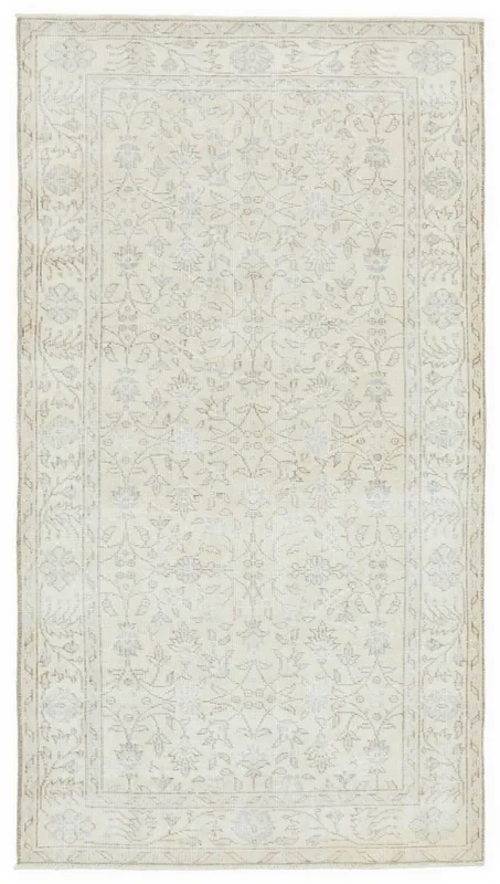 Full overhead view of the 4x7 ivory vintage Anatolian rug on a white background