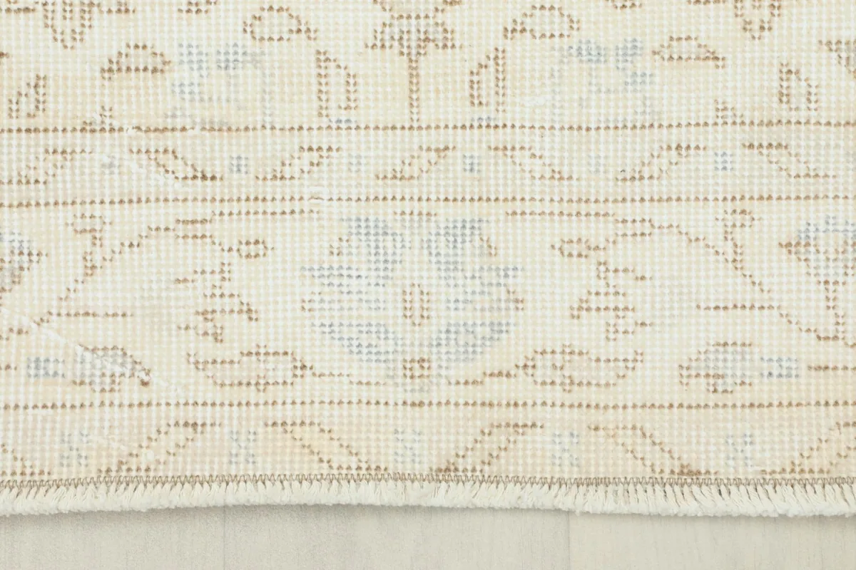 Close-up of the rug's border and fringe, showing the wool texture and cotton foundation