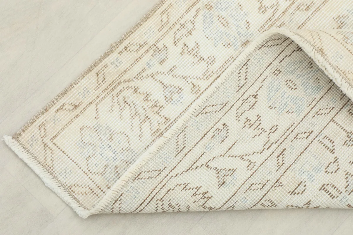 View of the rug's underside, revealing the hand-knotted construction and cotton foundation