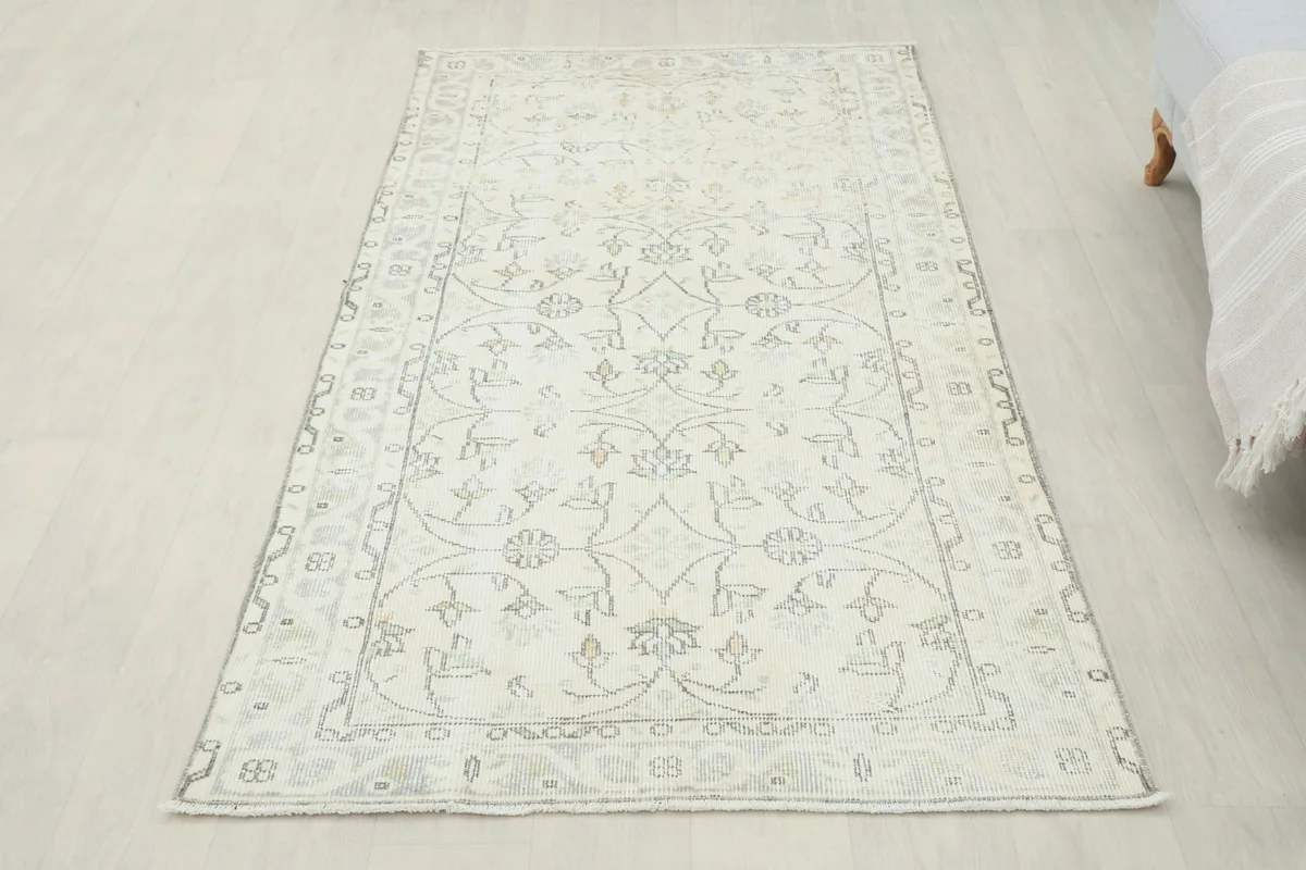 Full overhead view of the ivory floral vintage rug, showcasing its rectangular shape and design
