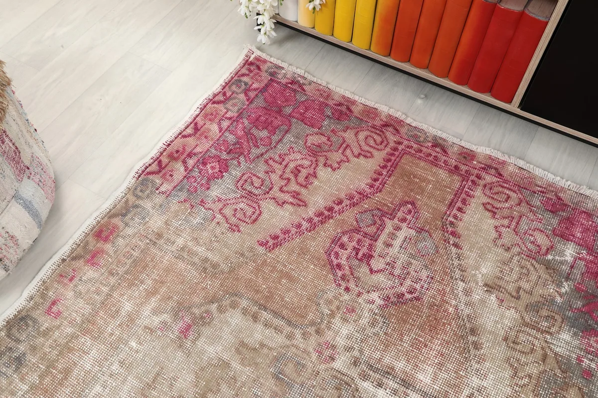 Overhead angle showing the upper left corner of the rug and its patterns