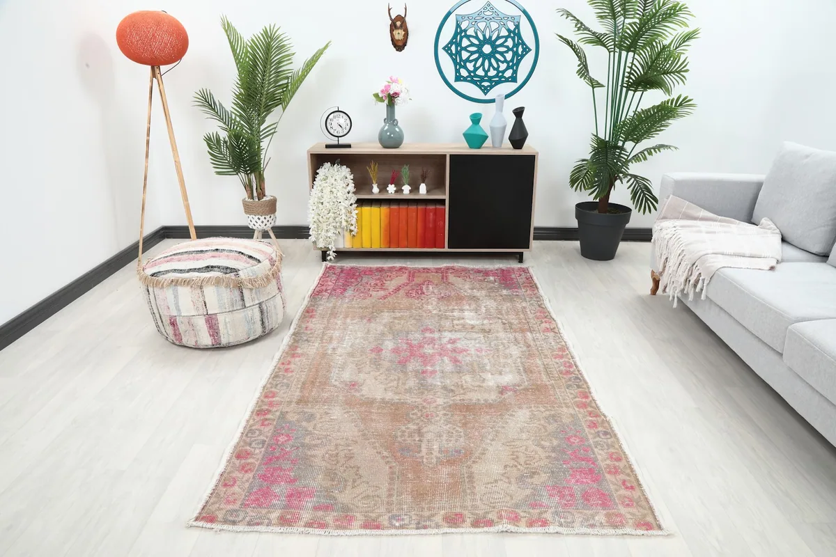 Vintage tan and rose area rug placed in a modern living room setting