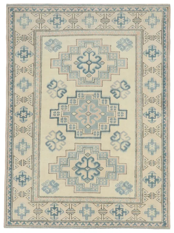 Full overhead view of the 5'8" x 7'9" vintage Anatolian rug with ivory, blue, and rose geometric patterns.