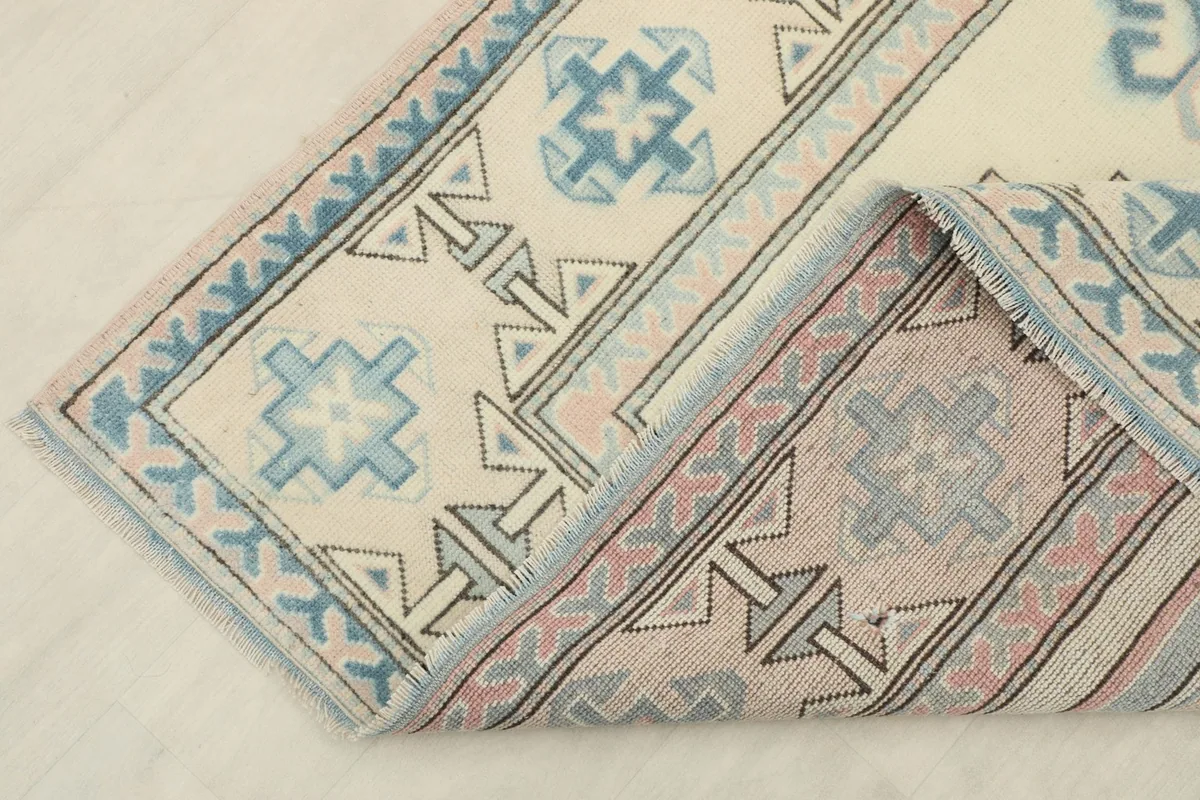 View showing the back of the hand-knotted wool rug, revealing the cotton foundation and construction.