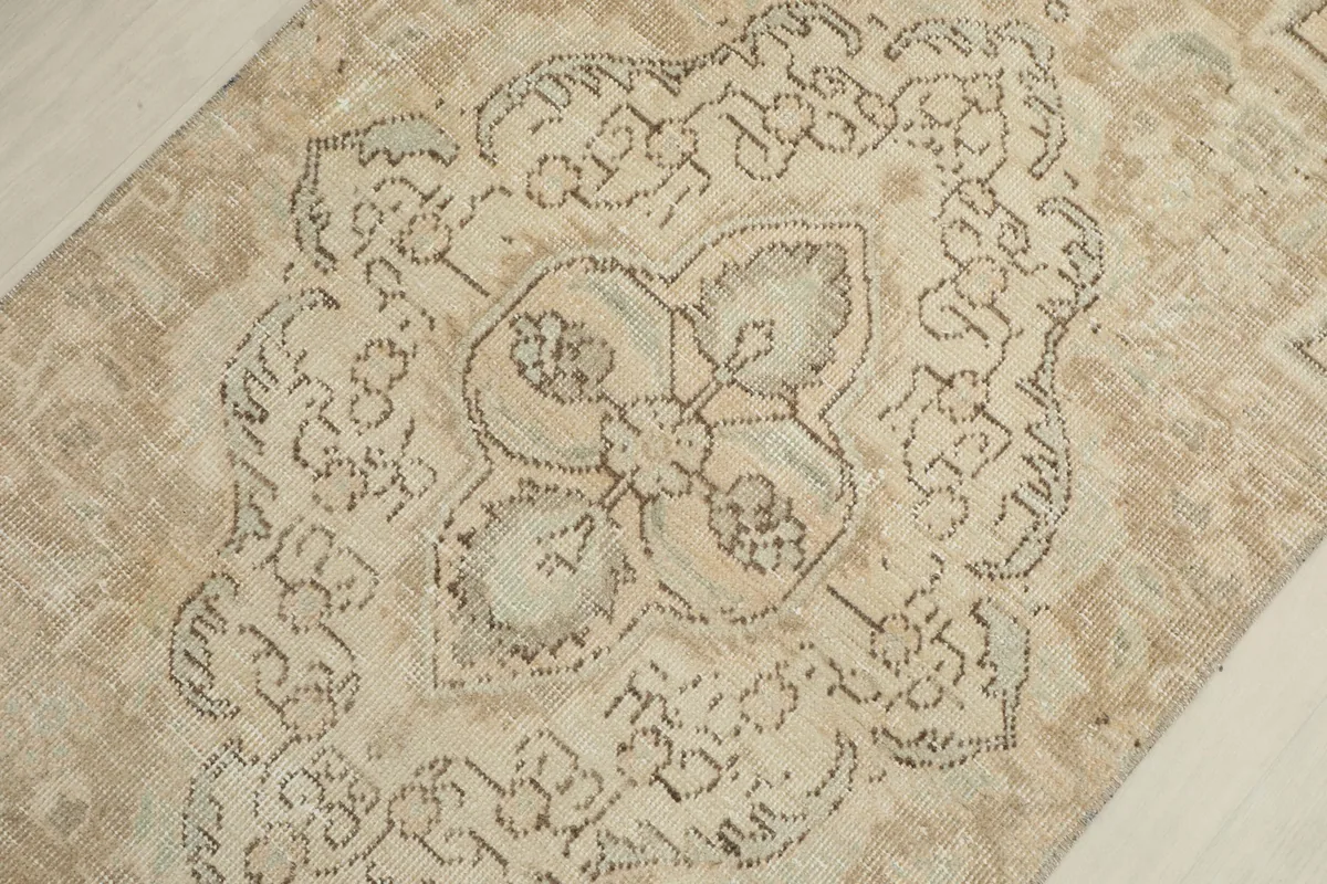 Close-up of the central medallion pattern, revealing the intricate details and color variations.