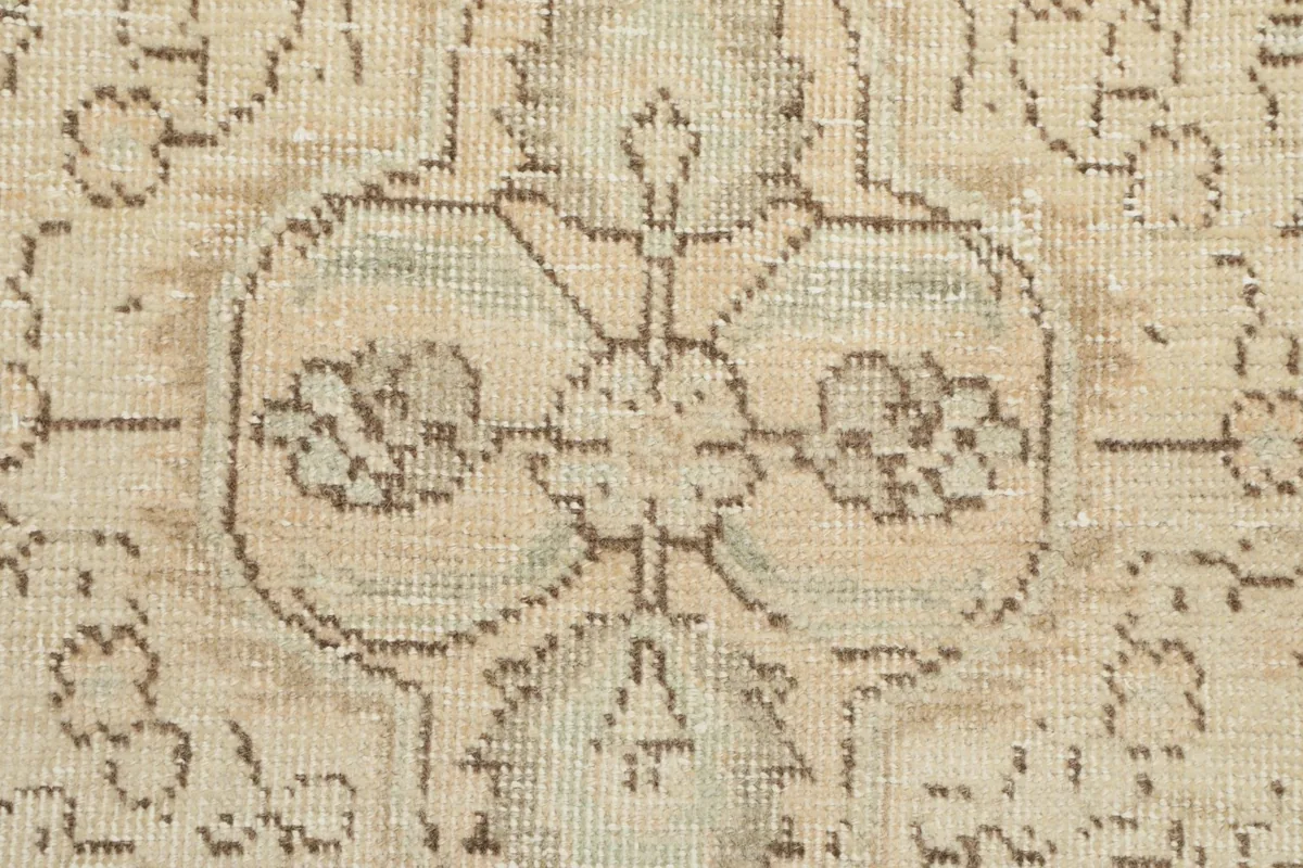 Detailed view of the low wool pile and the hand-knotted texture of the vintage rug.