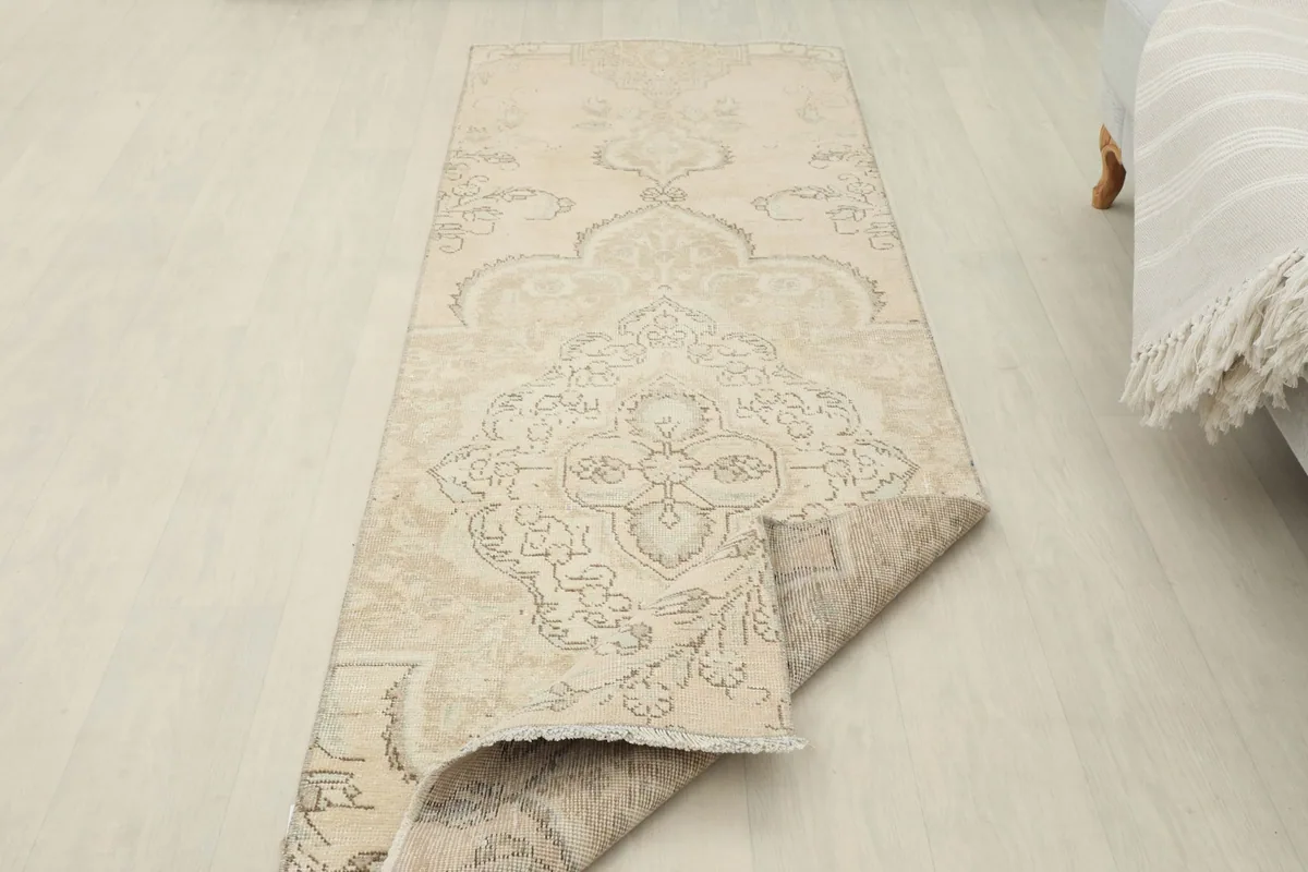 Runner rug with one end folded over, displaying the full length and the underside.