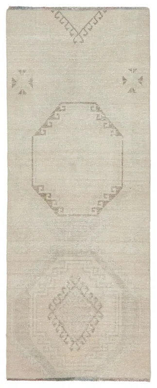 Full overhead view of the beige vintage Anatolian runner rug with tan geometric patterns.