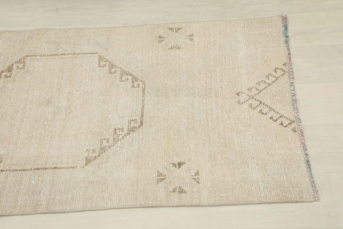 Close-up of the upper section of the runner, showing a tan octagonal motif and subtle pile variation.