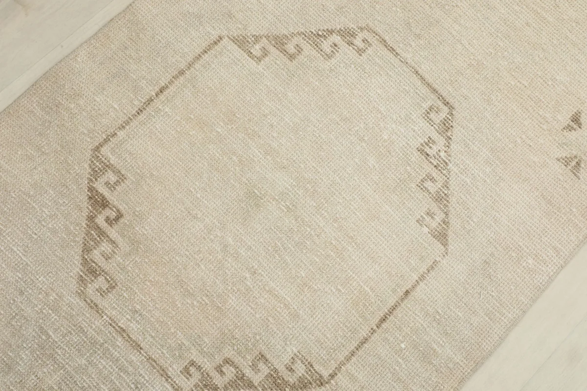 Detailed view of the central octagonal geometric pattern with its intricate tan border.