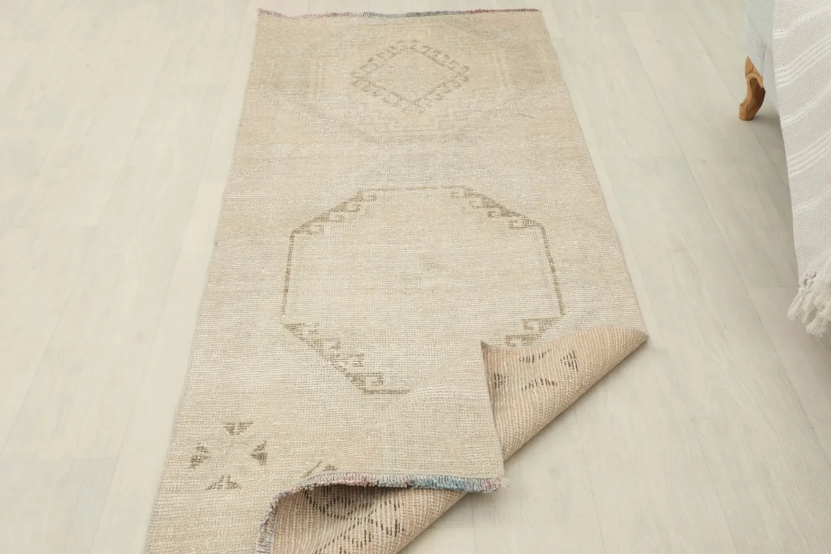 Runner rug with one end folded back, showcasing the full length and the reverse side.