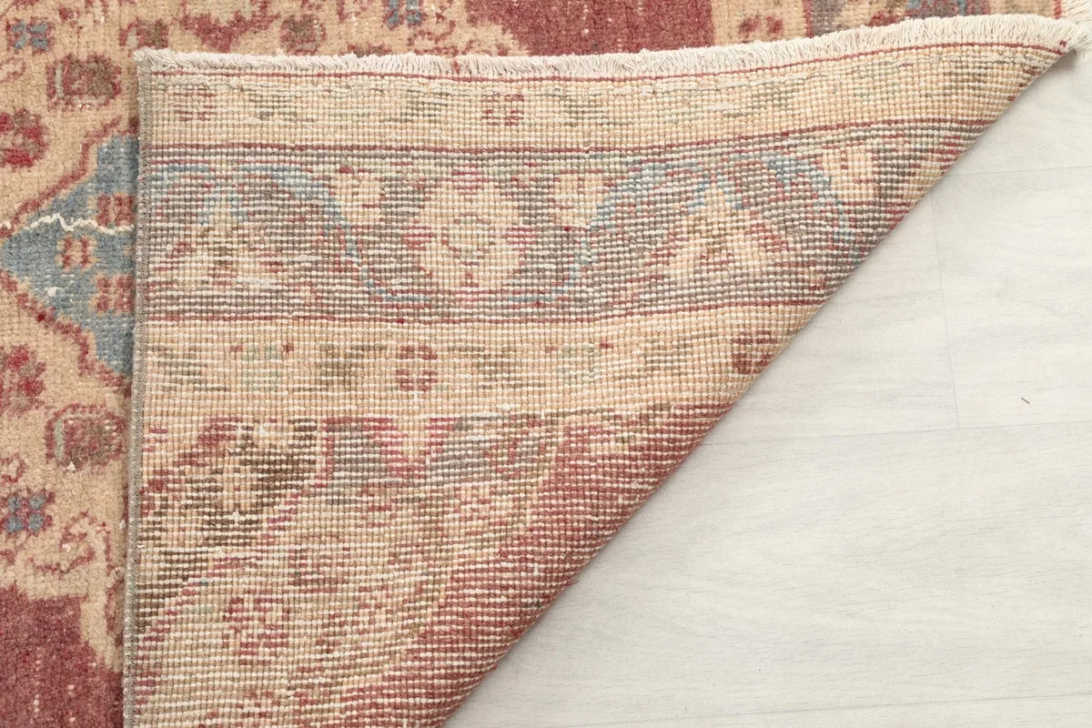 Close-up of the rug's underside, revealing the intricate hand-knotting and material