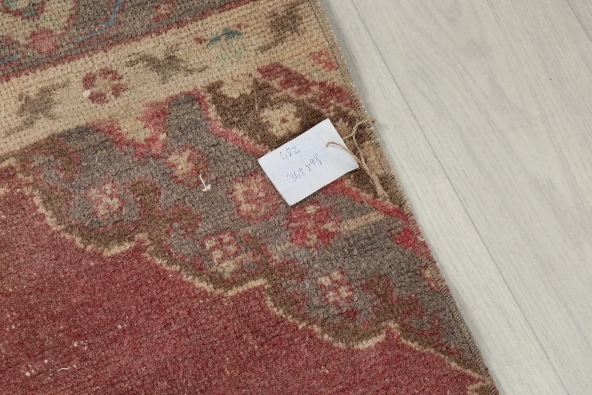 Detail of the rug's fringe and a small tag, showing the natural fiber ends