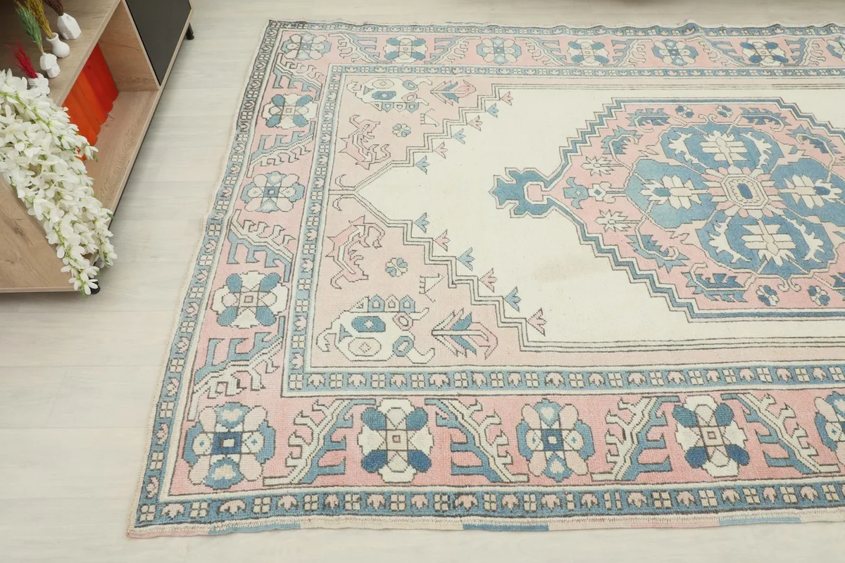 Side angle view highlighting the rug's color palette and the intricate design of the main field and border.