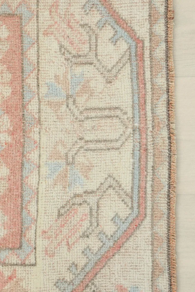 Close-up of the beige border and fringe, showing the intricate geometric patterns