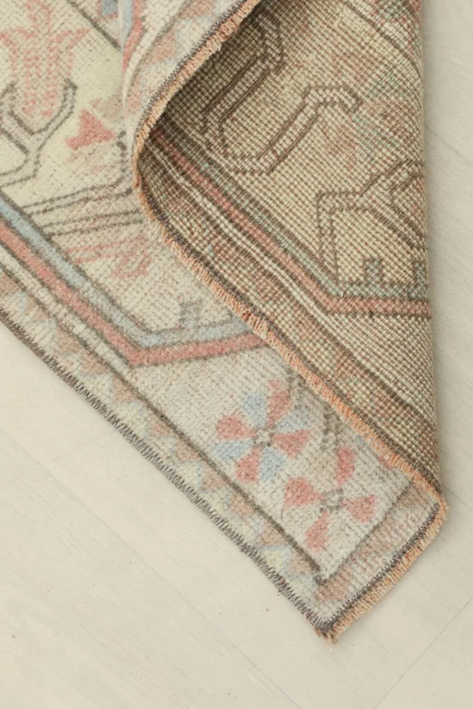 View of the back of the hand-knotted rug, revealing the cotton foundation and knotting