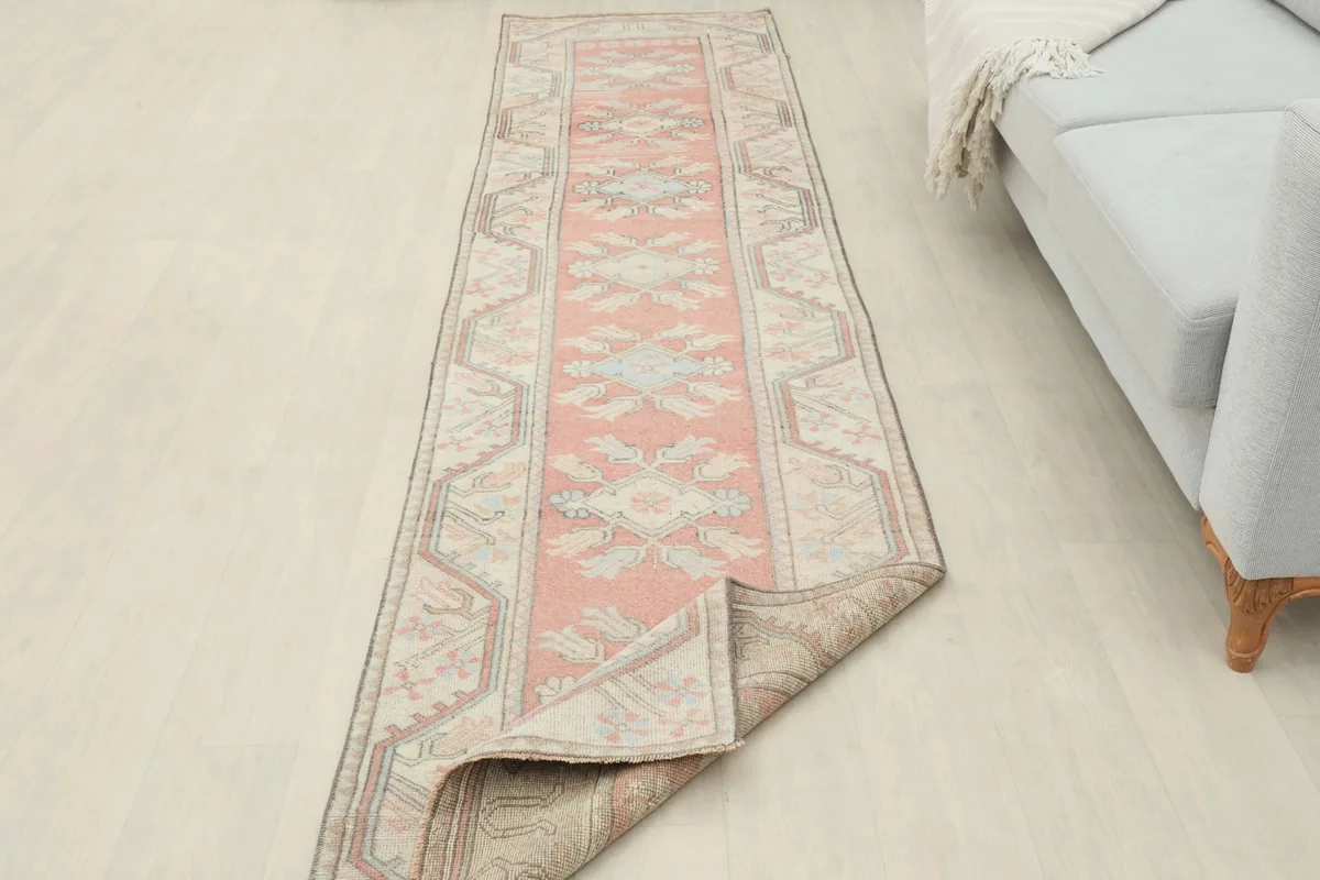 Runner partially folded back, showing the back of the rug and the professional cleaning tag
