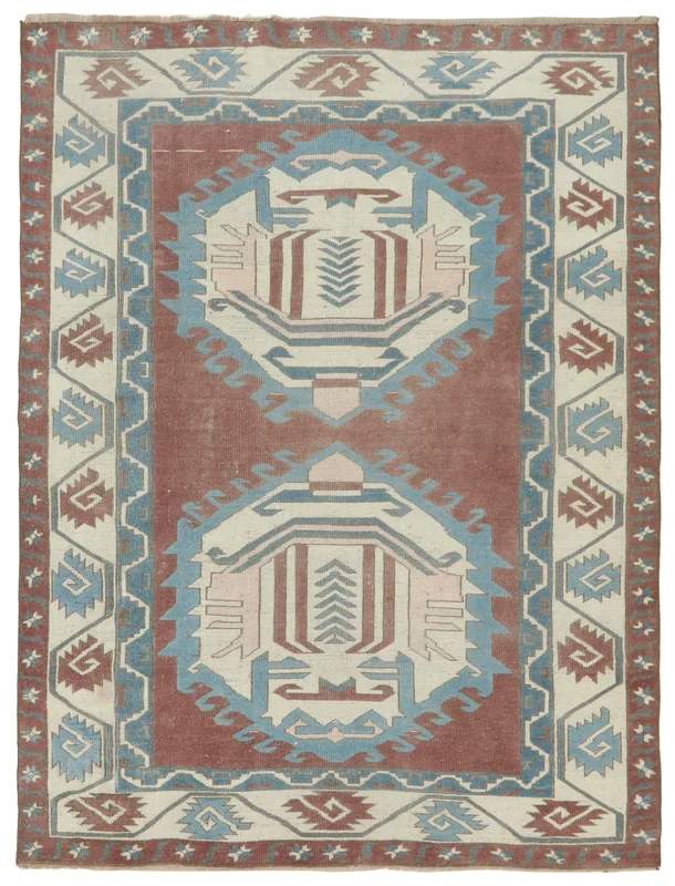 Full top view of the rust, blue, and ivory geometric vintage Anatolian rug.