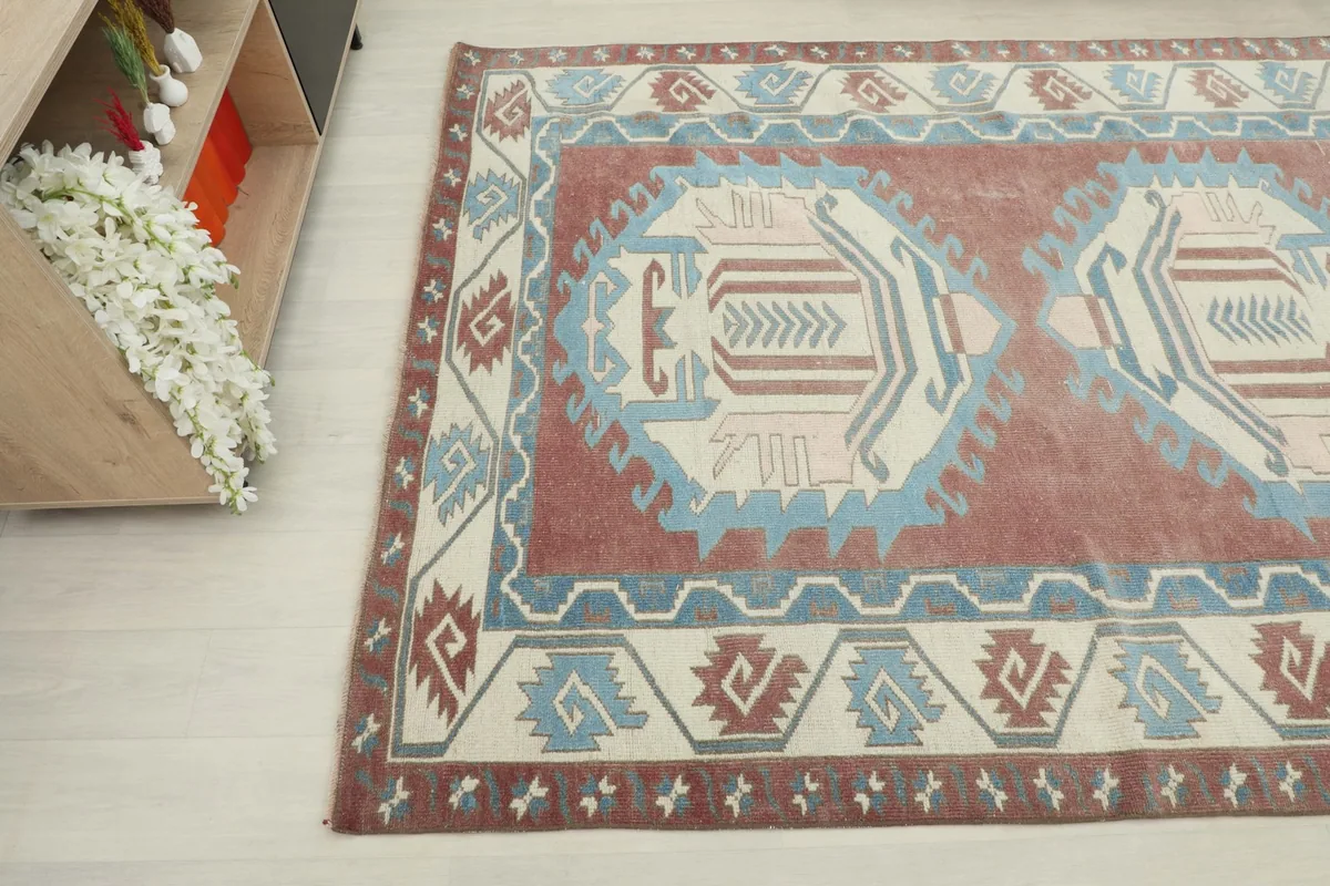 Overhead angle shot of the rug, showing the central medallions and border patterns.