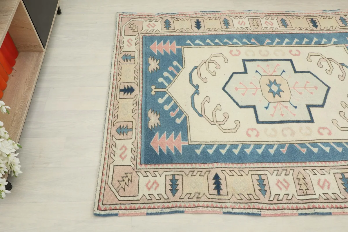 Detailed angle showing the geometric patterns and colors of the rug's border and field.